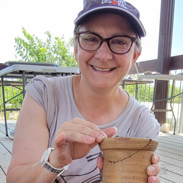 Tyler Jo Smith holding a ceramic wine jar