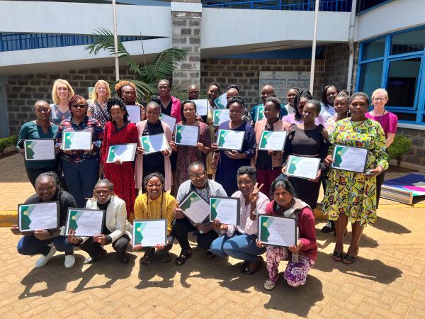 Group photo with participants holding certificates